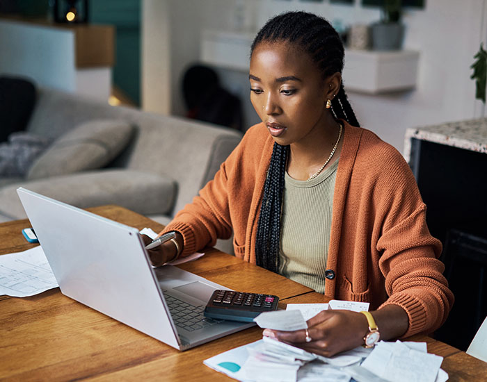 Black woman, budget and home finance on laptop for accounting